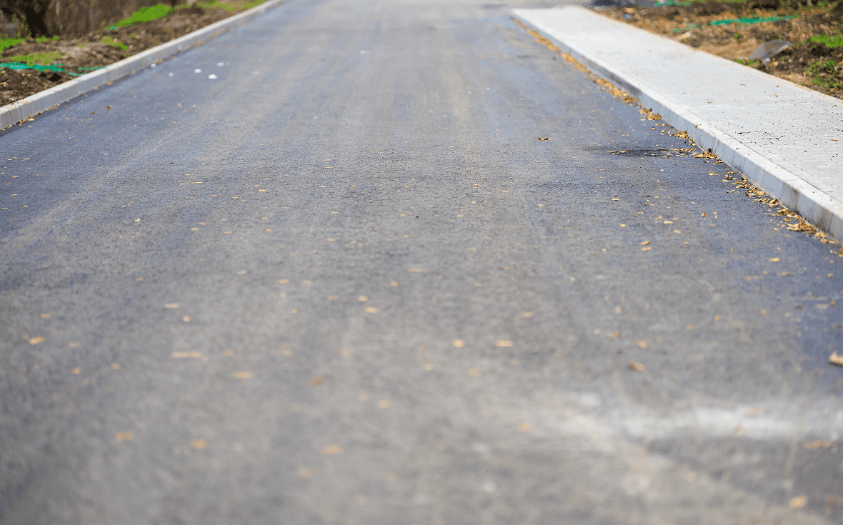 Smooth blacktop road with adjacent sidewalk